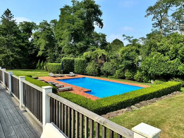 a view of a balcony with yard