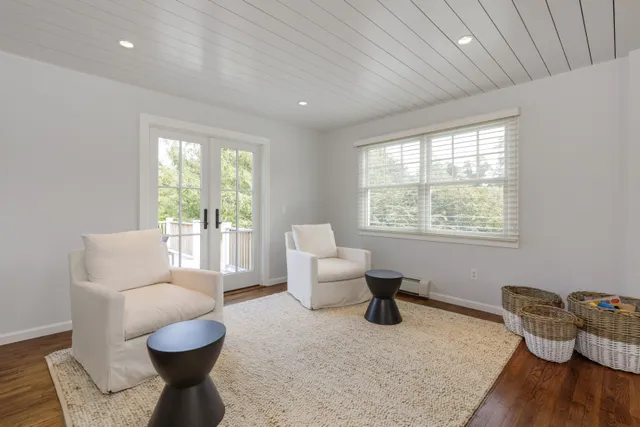 a bedroom with furniture and a large window