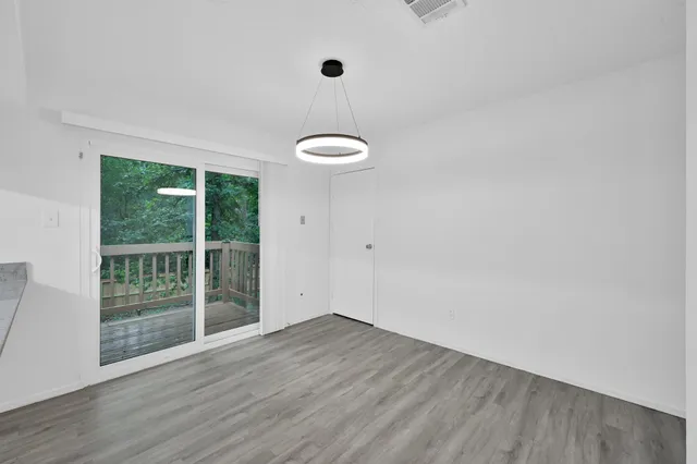a view of a room with wooden floor and iron gate
