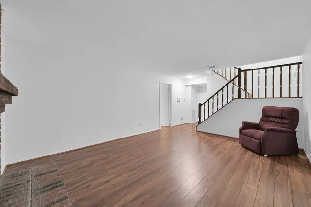 a hallway with wooden floor and glass door
