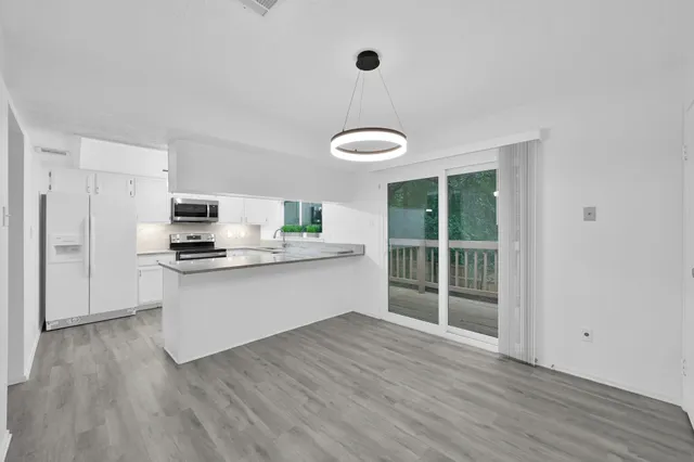 a kitchen with stainless steel appliances granite countertop a stove a sink and a refrigerator