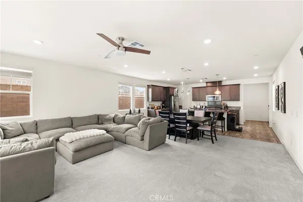 a living room with furniture and kitchen view