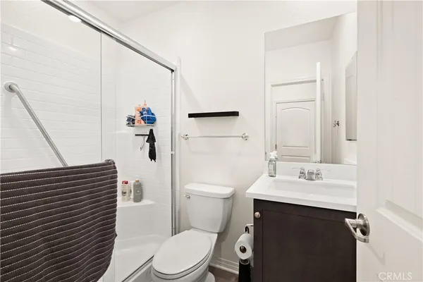 a bathroom with a sink a toilet and shower curtain