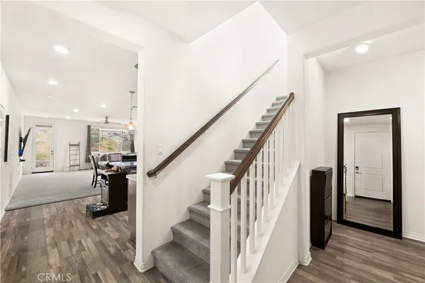 a view of entryway and hall with wooden floor