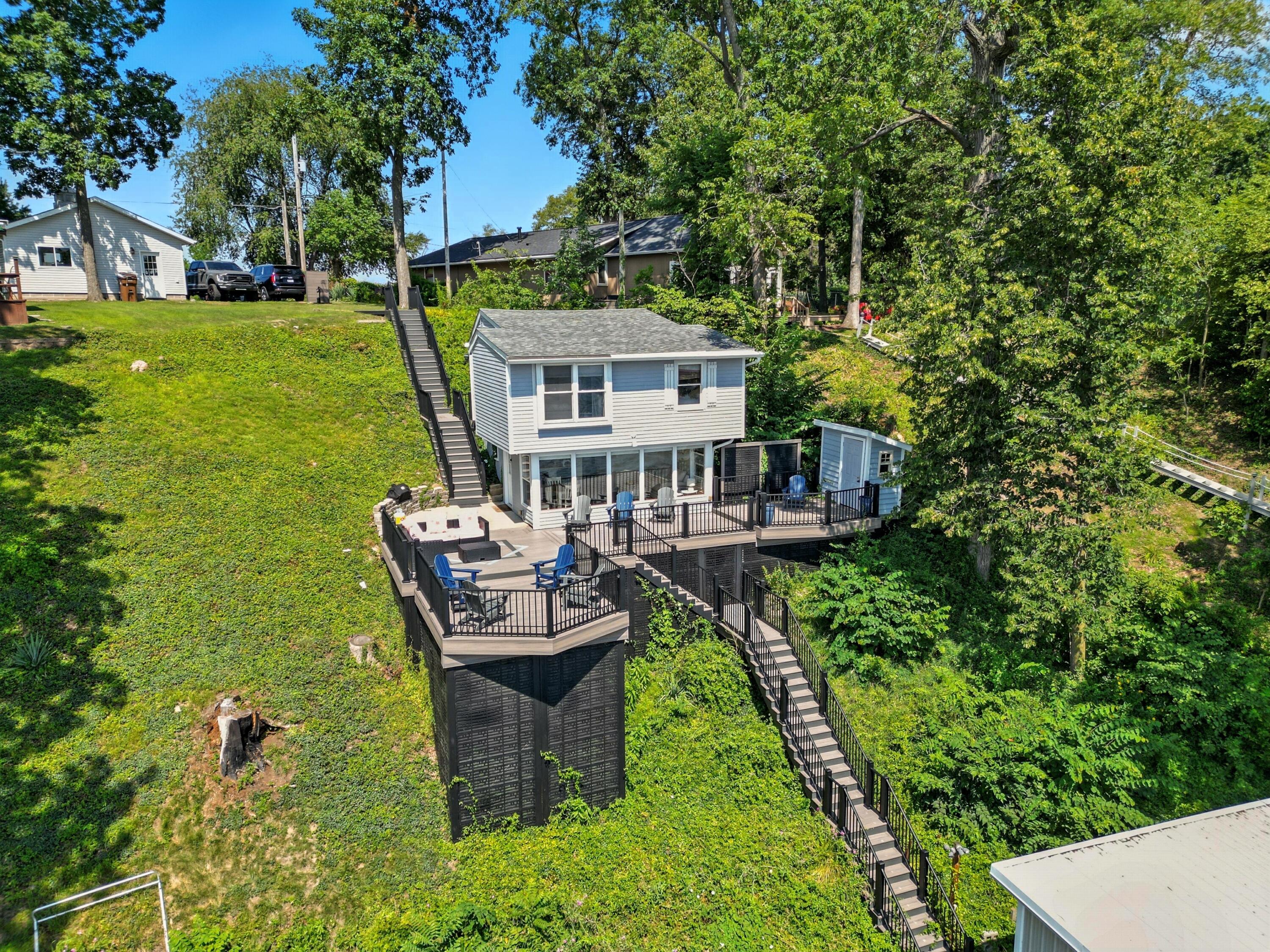 a view of a house with backyard sitting area and garden