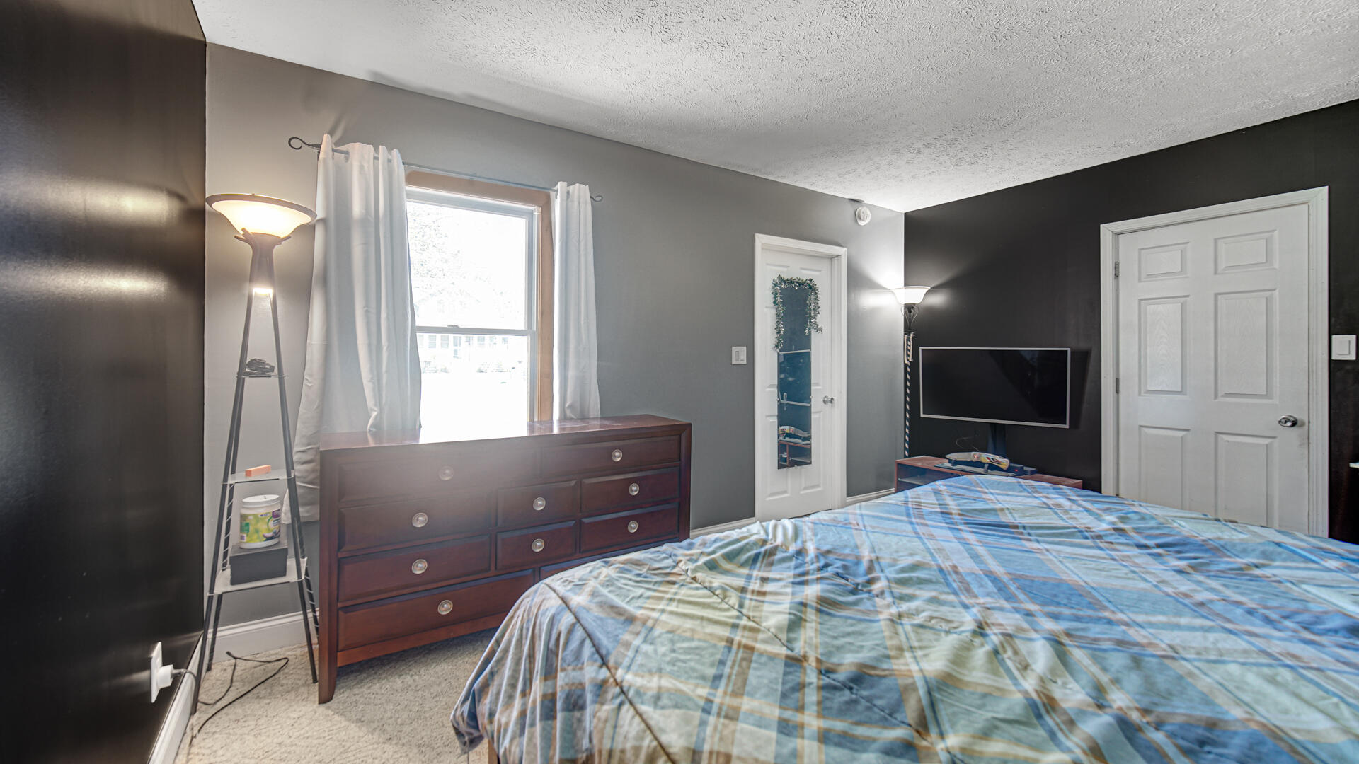 324 West Johnson Road La Porte, IN 46350 - Photo 14 of 34 a bedroom with a bed and a flat screen tv