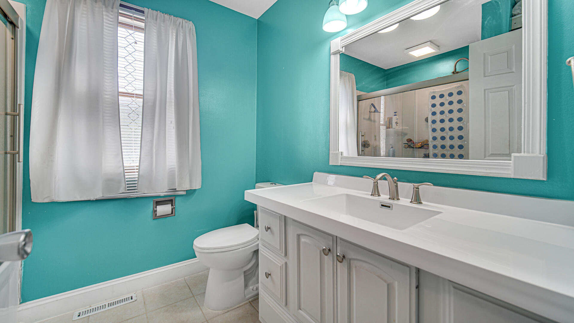 324 West Johnson Road La Porte, IN 46350 - Photo 18 of 34 a bathroom with a sink a toilet and a mirror