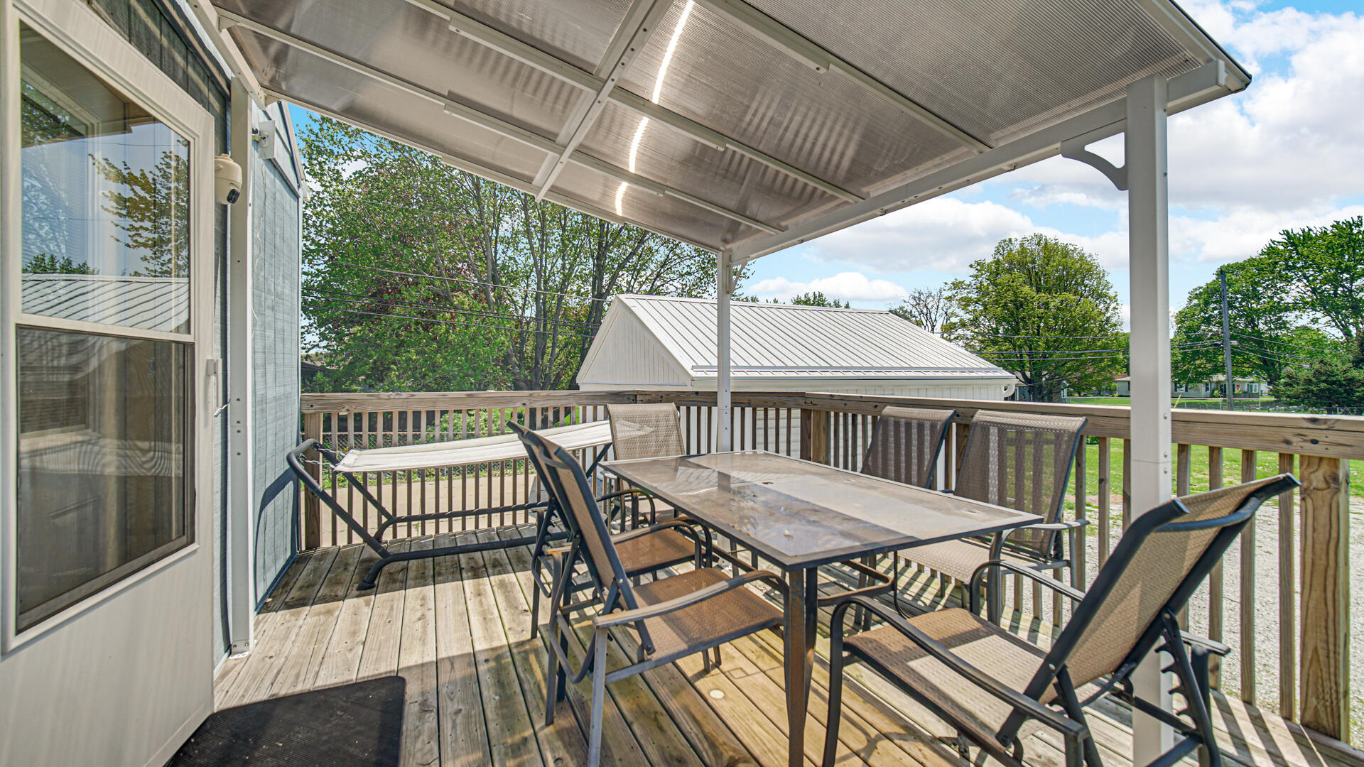 324 West Johnson Road La Porte, IN 46350 - Photo 25 of 34 a view of a patio with a table chairs and a porch