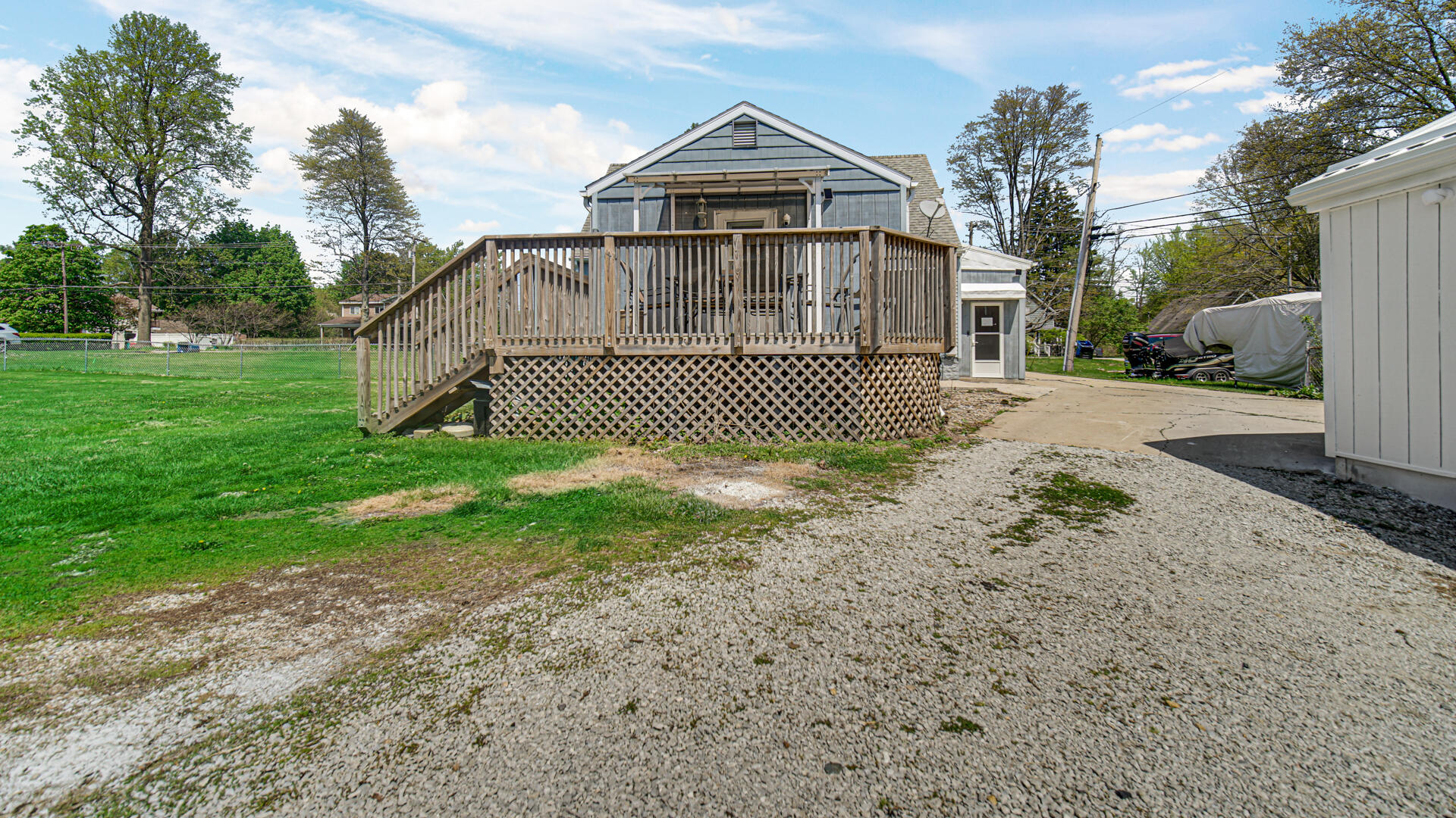 324 West Johnson Road La Porte, IN 46350 - Photo 26 of 34 a view of a wooden house with a yard and large trees