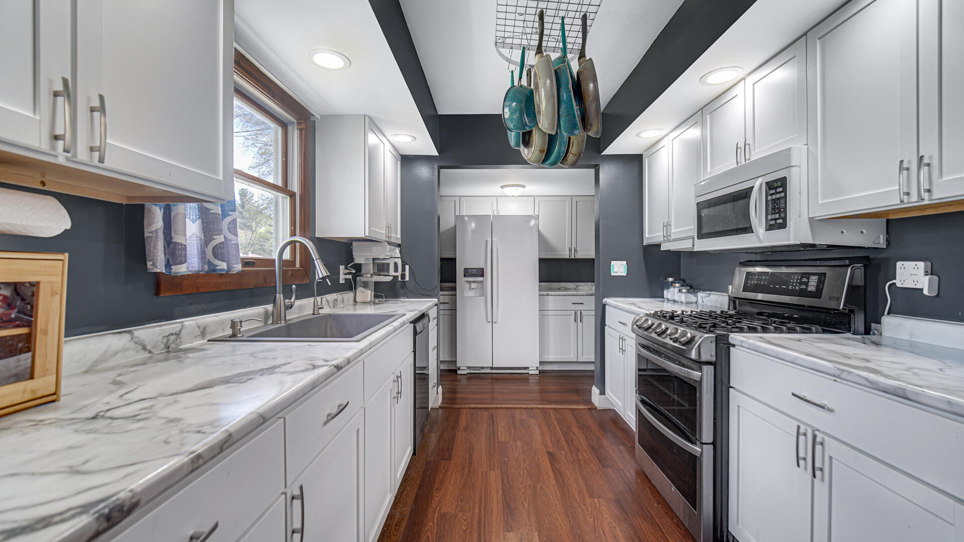 324 West Johnson Road La Porte, IN 46350 - Photo 8 of 34 a kitchen with stainless steel appliances granite countertop a sink a stove and a refrigerator