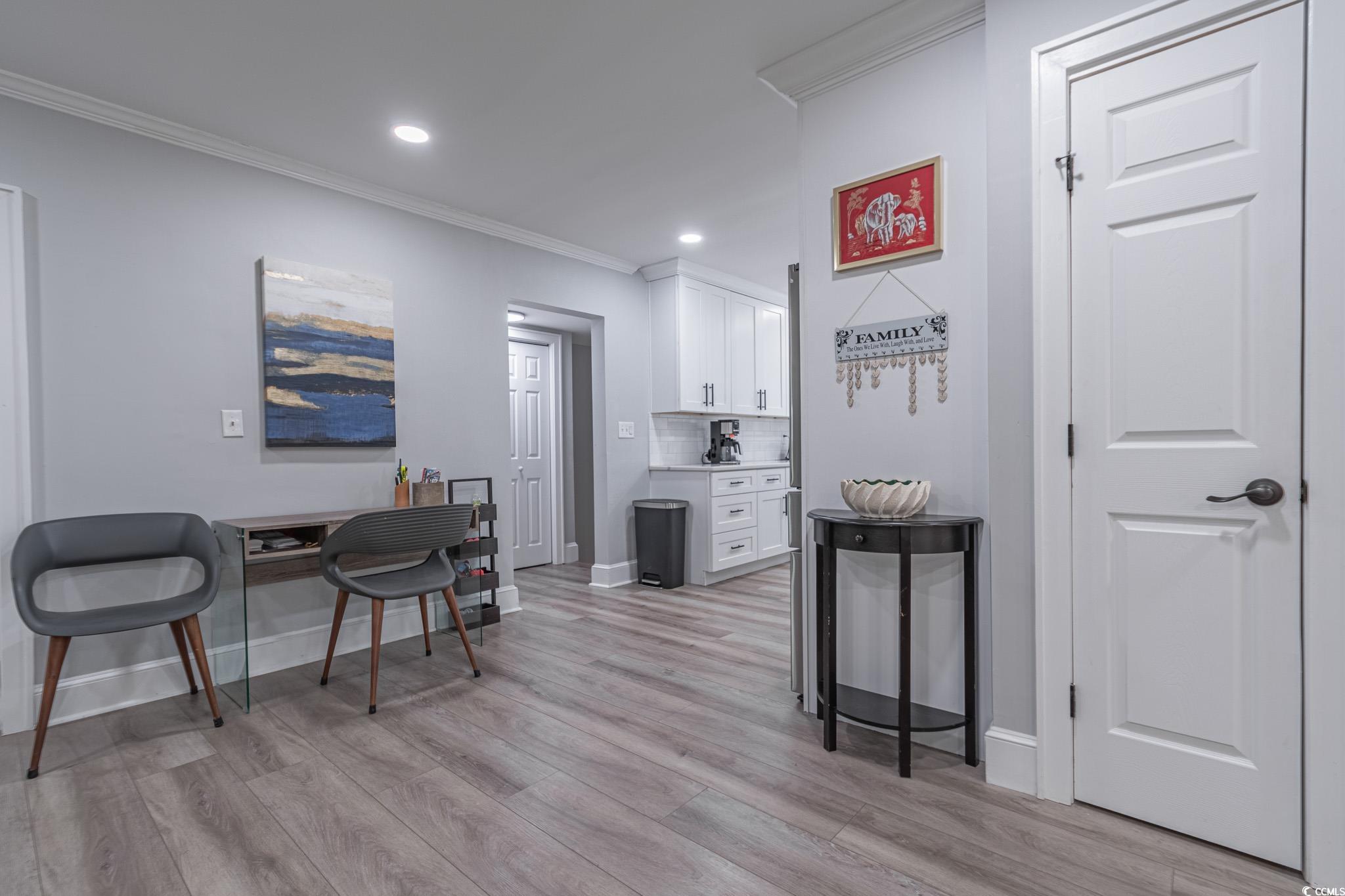5307 North Ocean Boulevard Myrtle Beach, SC 29577 - Photo 12 of 39 Kitchen with white cabinetry, ornamental molding, light wood-style floors, decorative backsplash, and recessed lighting