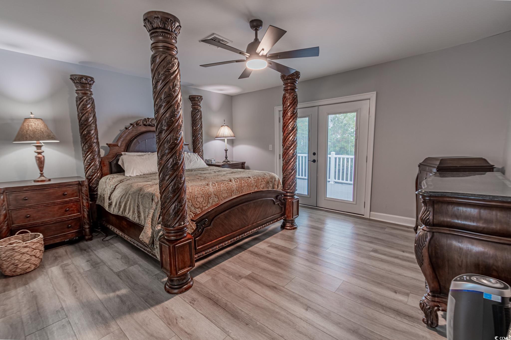 5307 North Ocean Boulevard Myrtle Beach, SC 29577 - Photo 20 of 39 Bedroom with a ceiling fan, access to exterior, wood finished floors, and french doors