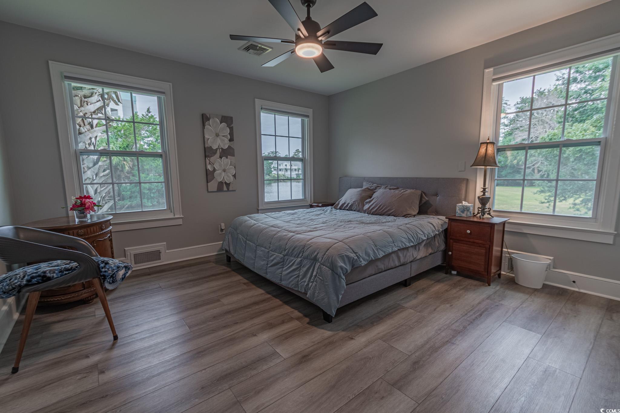 5307 North Ocean Boulevard Myrtle Beach, SC 29577 - Photo 24 of 39 Bedroom featuring multiple windows, wood finished floors, and ceiling fan