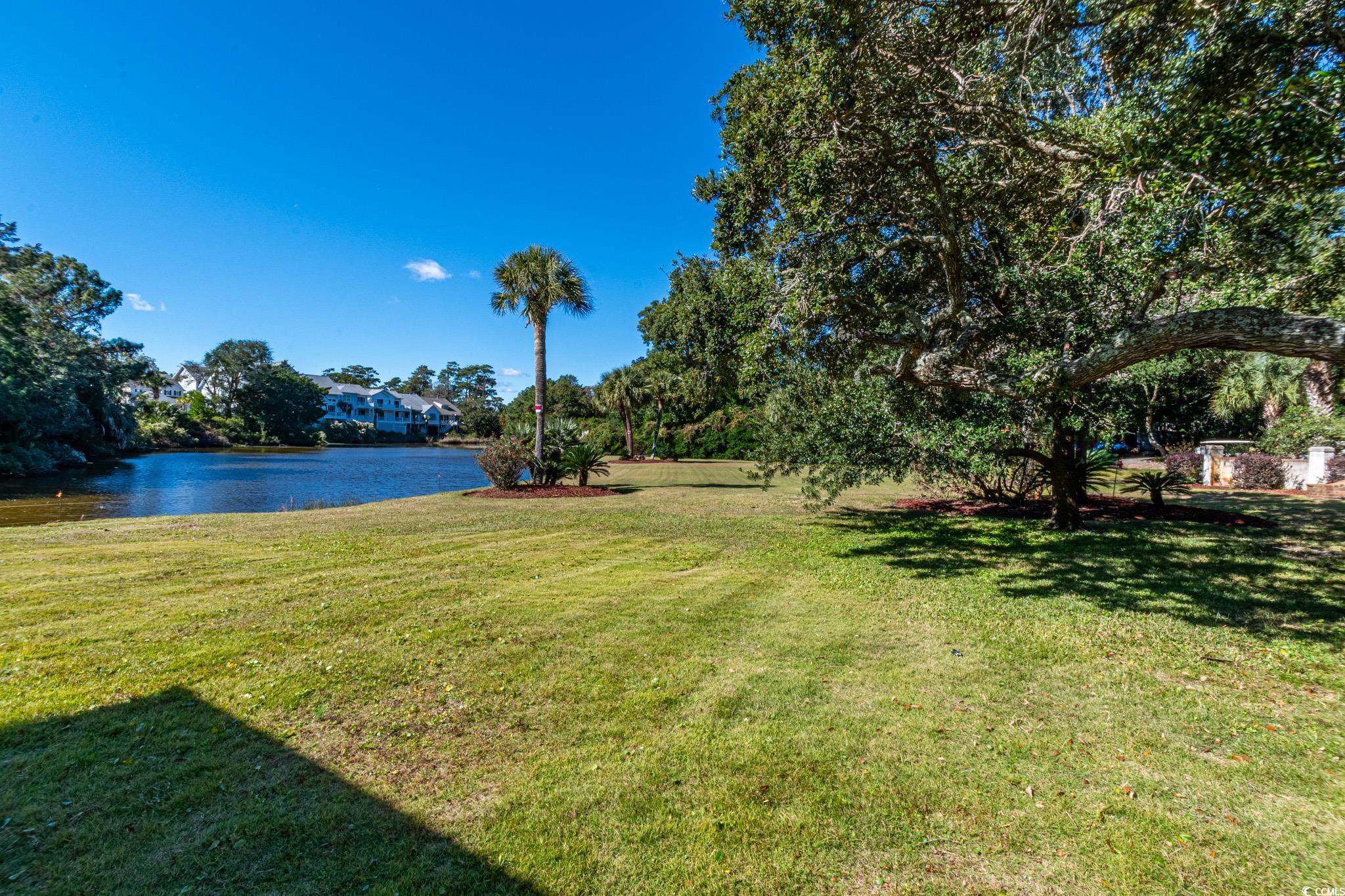 5307 North Ocean Boulevard Myrtle Beach, SC 29577 - Photo 31 of 39 View of green lawn featuring a water view