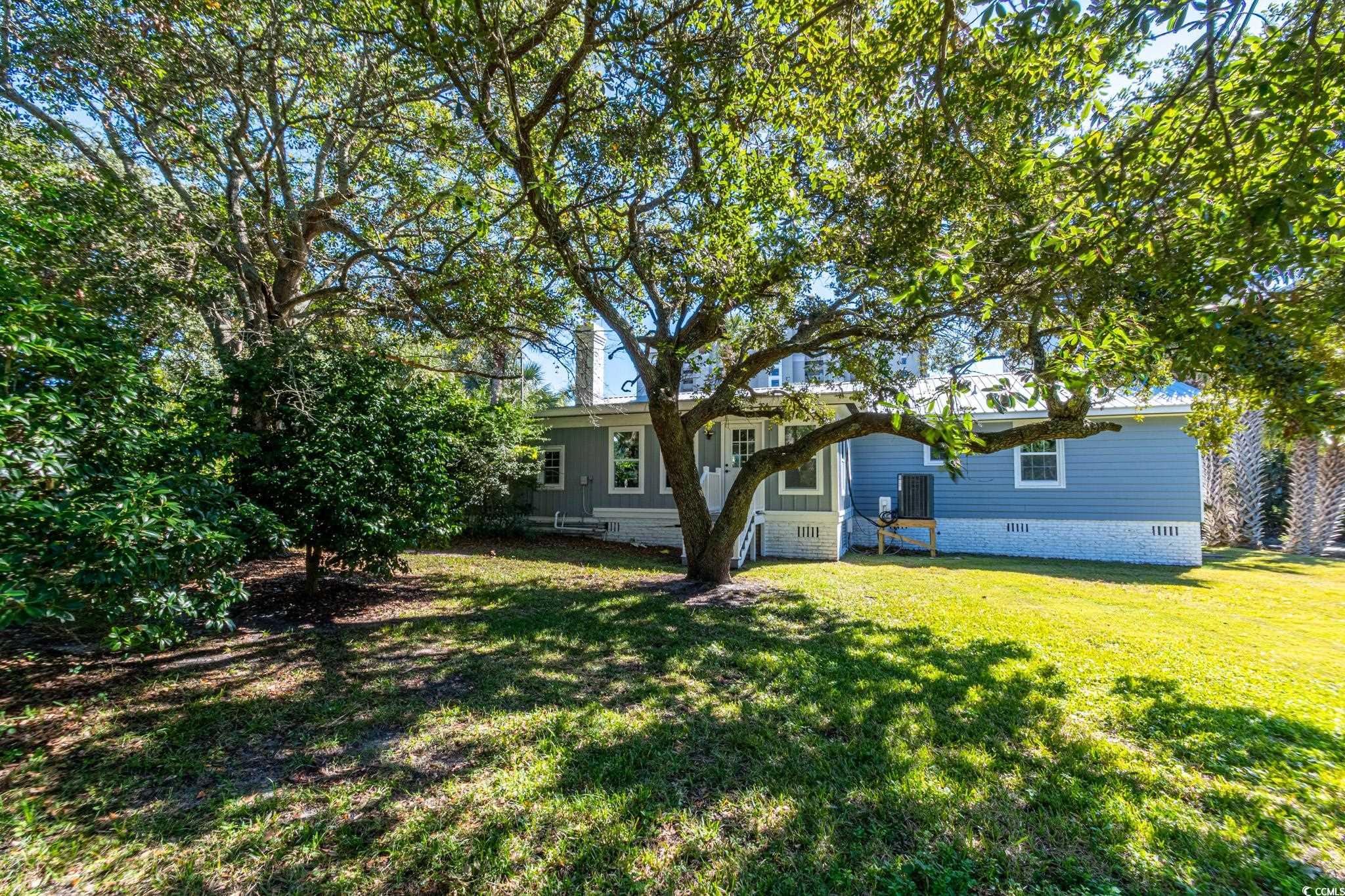 5307 North Ocean Boulevard Myrtle Beach, SC 29577 - Photo 34 of 39 Rear view of house featuring crawl space and a lawn