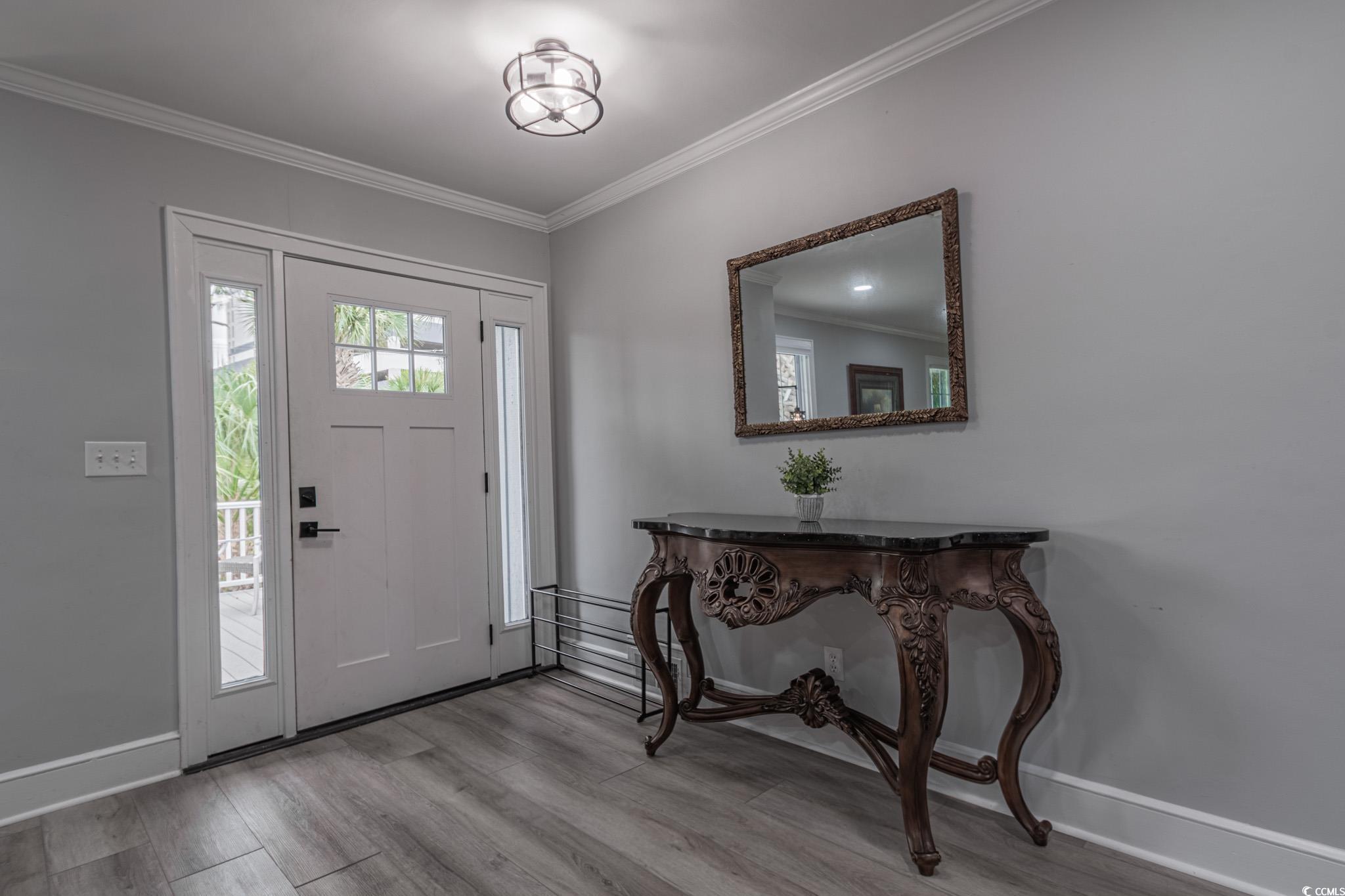 5307 North Ocean Boulevard Myrtle Beach, SC 29577 - Photo 6 of 39 Entrance foyer featuring ornamental molding and wood finished floors
