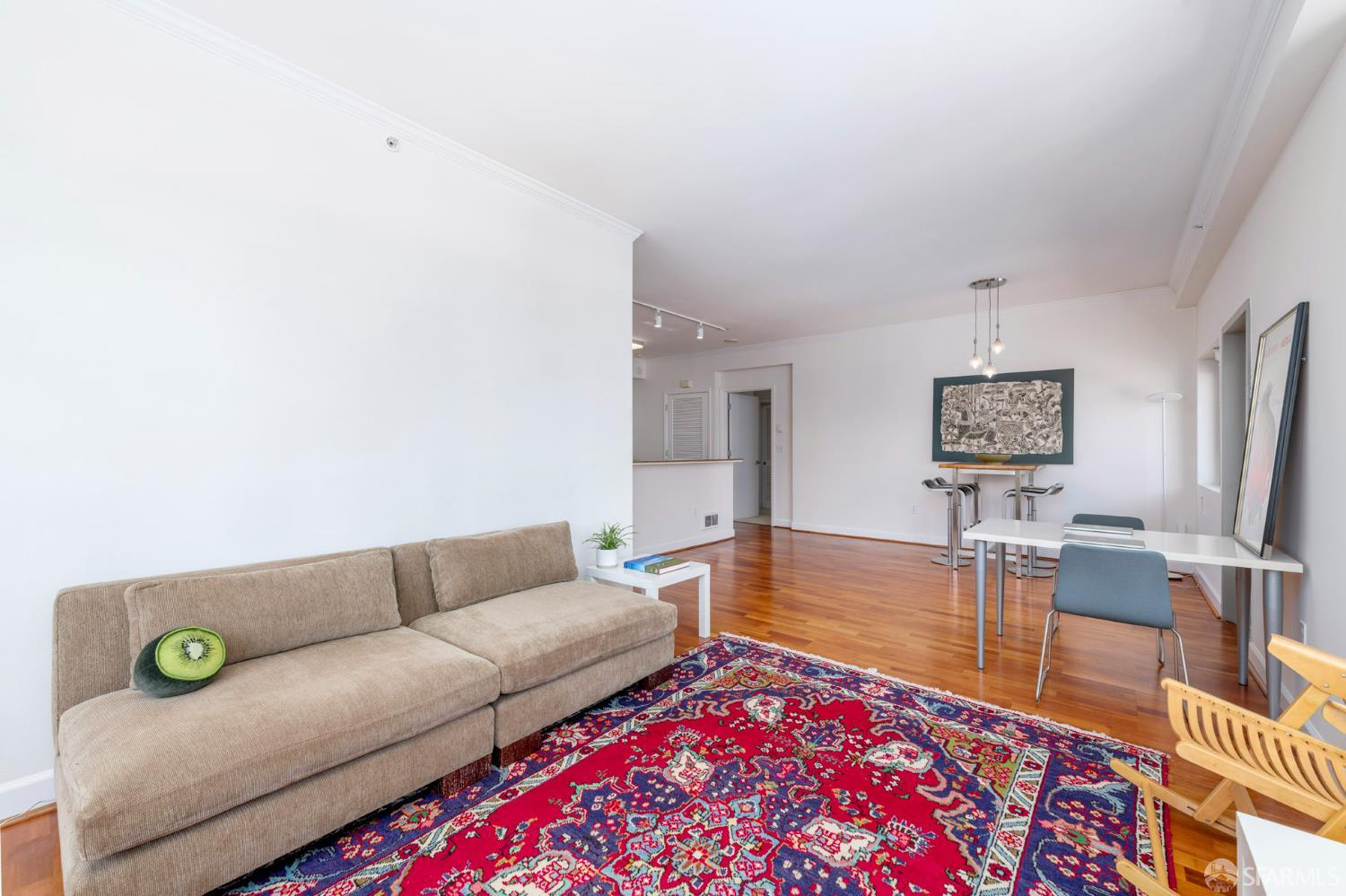 246 2nd Street, Unit 703 San Francisco, CA 94105 - Photo 12 of 30 a living room with furniture and a wooden floor