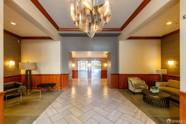 a lobby with furniture and a chandelier