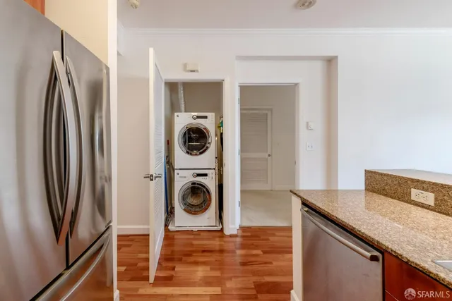 a kitchen with stainless steel appliances granite countertop a refrigerator and a sink
