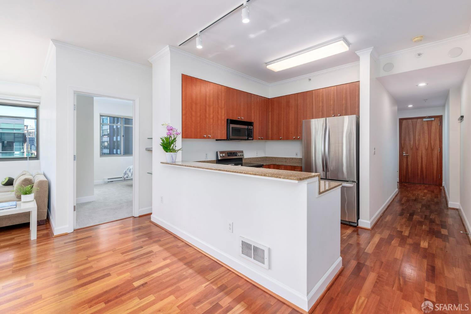 246 2nd Street, Unit 703 San Francisco, CA 94105 - Photo 7 of 30 a kitchen with granite countertop a refrigerator and a stove top oven