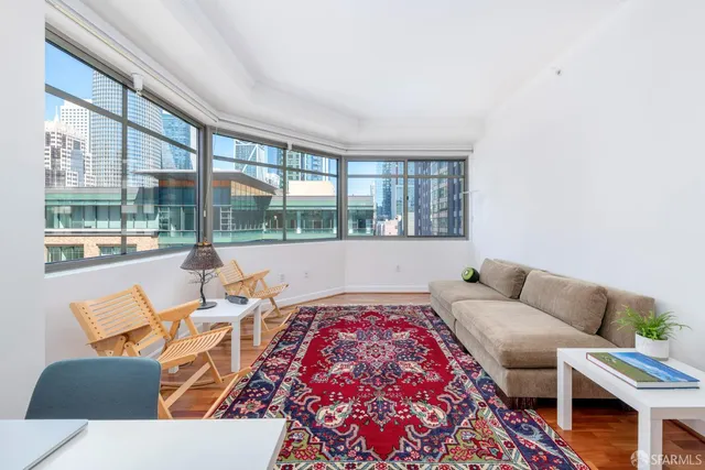 a living room with furniture and a floor to ceiling window