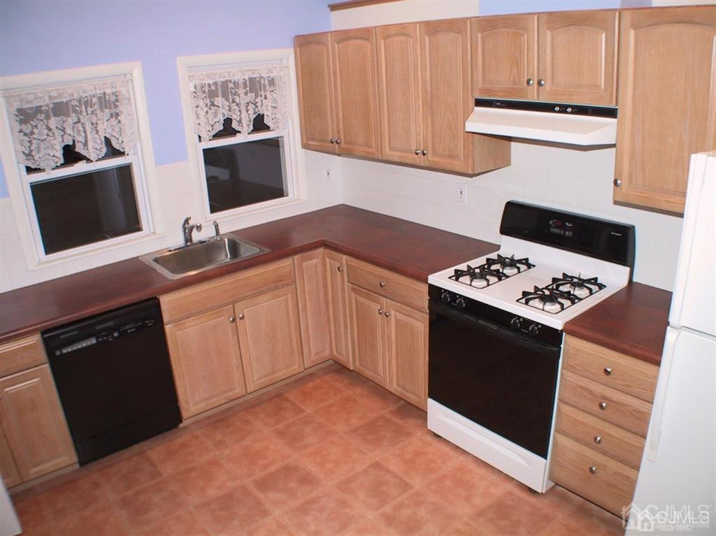 38 Hamilton Road Hillsborough, NJ 08844 - Photo 25 of 28 a kitchen with stainless steel appliances a stove a microwave and a refrigerator