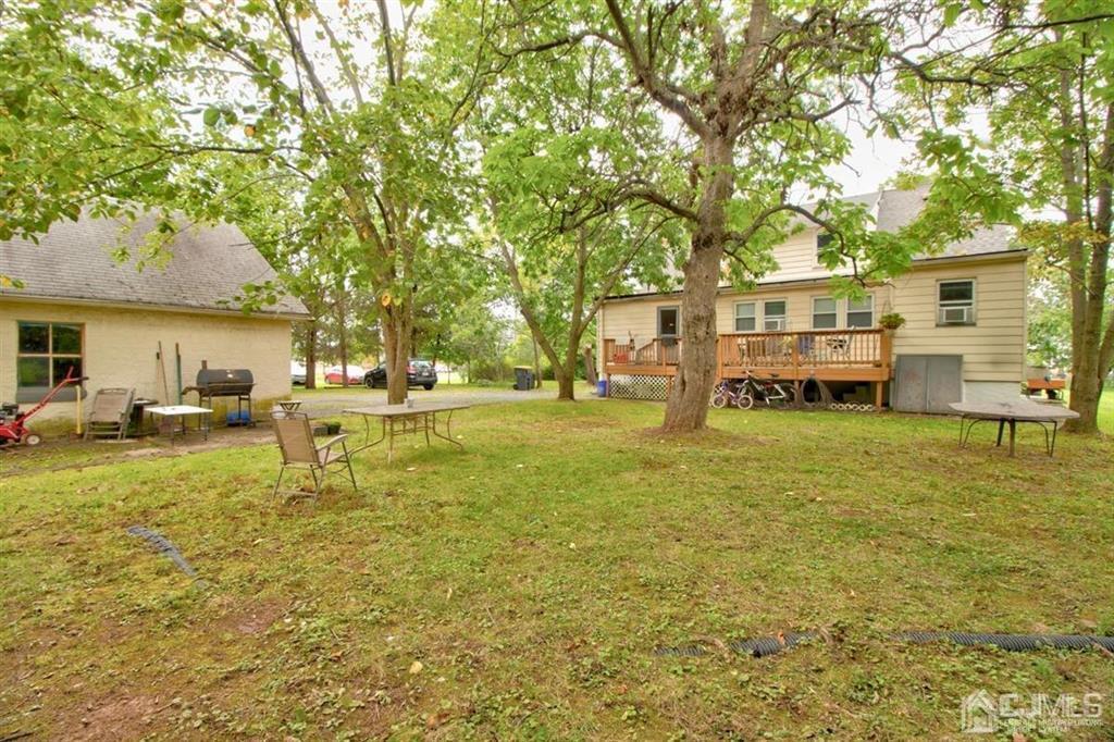 38 Hamilton Road Hillsborough, NJ 08844 - Photo 5 of 28 a backyard of a house with table and chairs