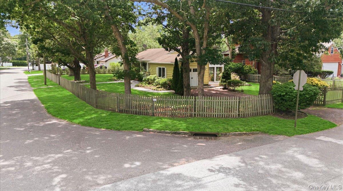 10 Graham Road Hampton Bays, NY 11946 - Photo 3 of 26 a front view of a house with a yard