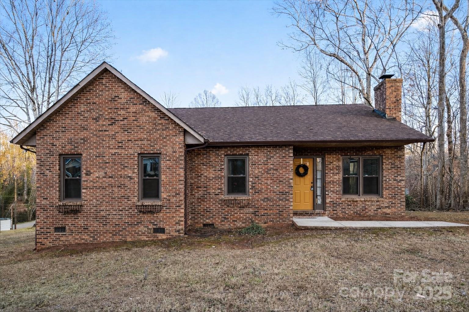 a view of a house with large windows and a yard