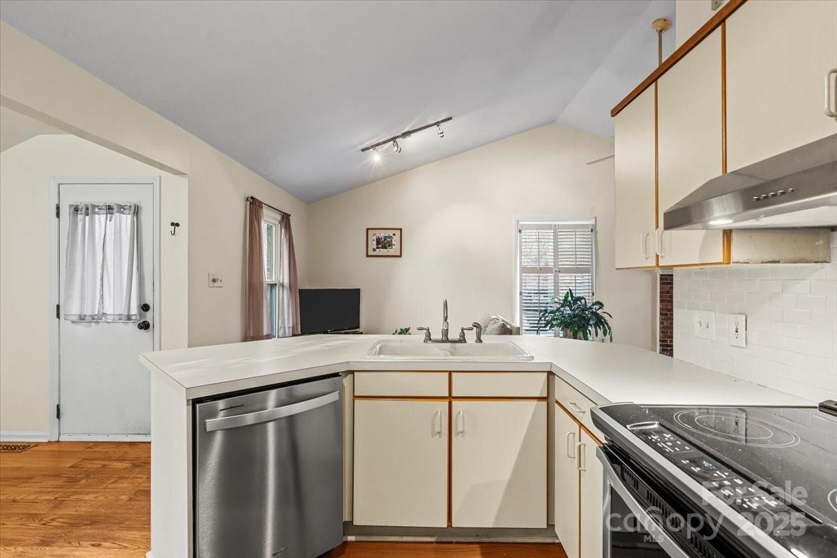 7022 Plott Road Charlotte, NC 28215 - Photo 11 of 27 a kitchen with a sink stove and cabinets