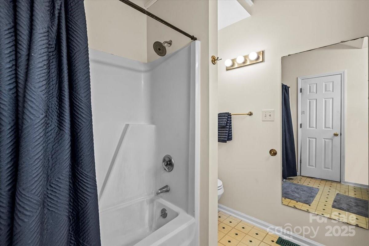 7022 Plott Road Charlotte, NC 28215 - Photo 19 of 27 a bathroom with a tub and shower