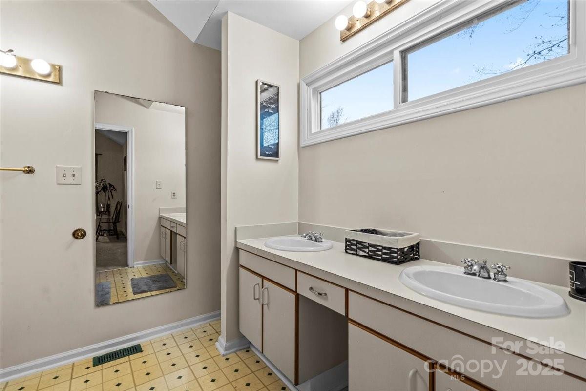 7022 Plott Road Charlotte, NC 28215 - Photo 20 of 27 a bathroom with a sink a vanity and a mirror
