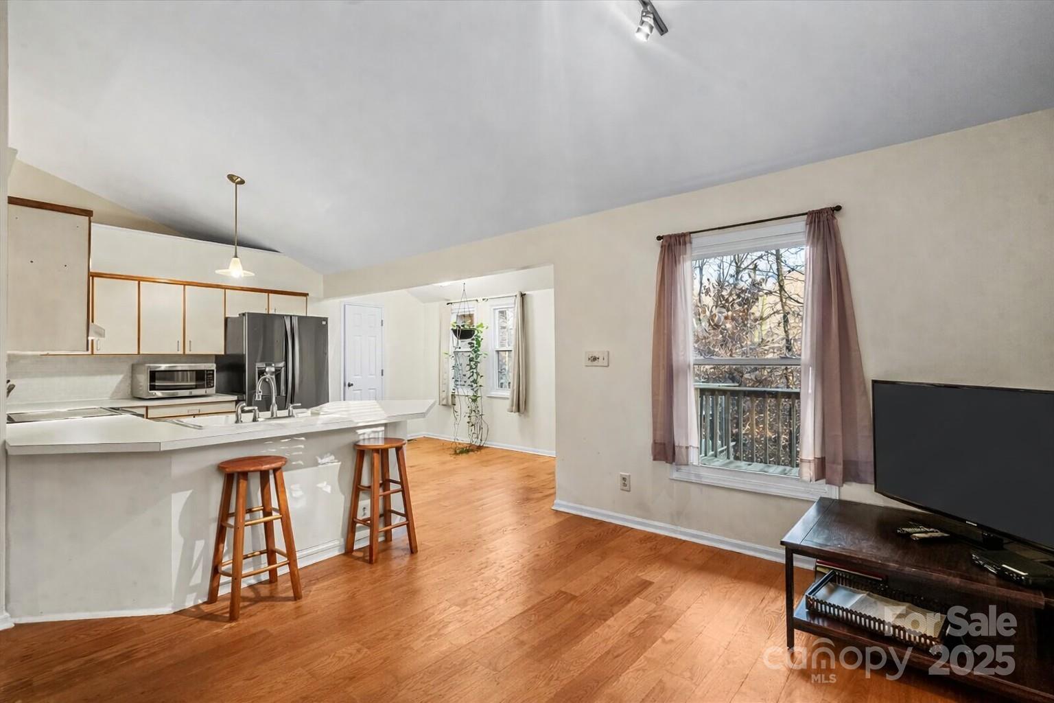 7022 Plott Road Charlotte, NC 28215 - Photo 9 of 27 a living room with stainless steel appliances furniture and a flat screen tv