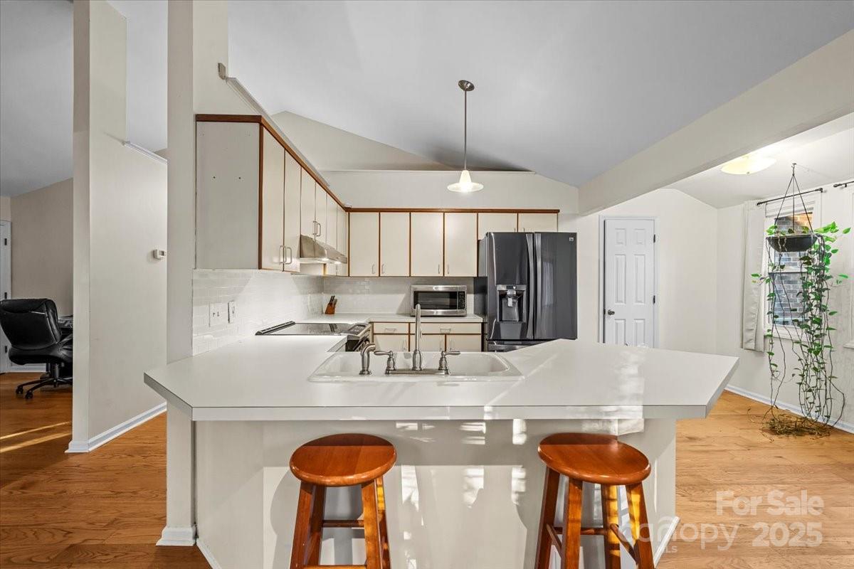 7022 Plott Road Charlotte, NC 28215 - Photo 10 of 27 a kitchen with stainless steel appliances granite countertop a sink a stove a refrigerator and island