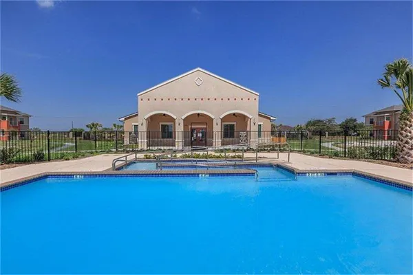 a view of a house with pool and a yard