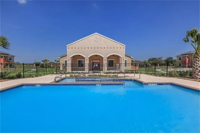 a view of a house with pool and a yard
