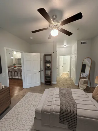 a bedroom with a large bed and a chandelier