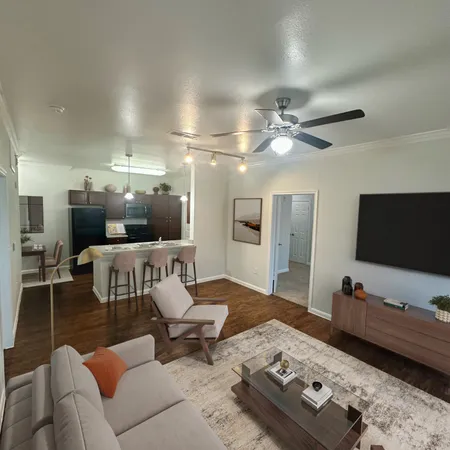 a living room with furniture and a flat screen tv