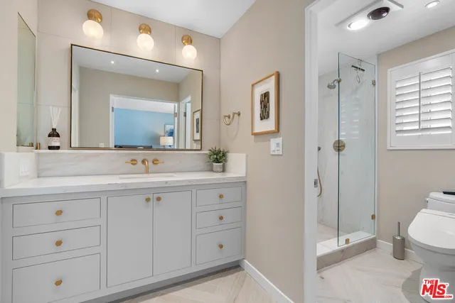 a bathroom with a double vanity sink mirror and toilet