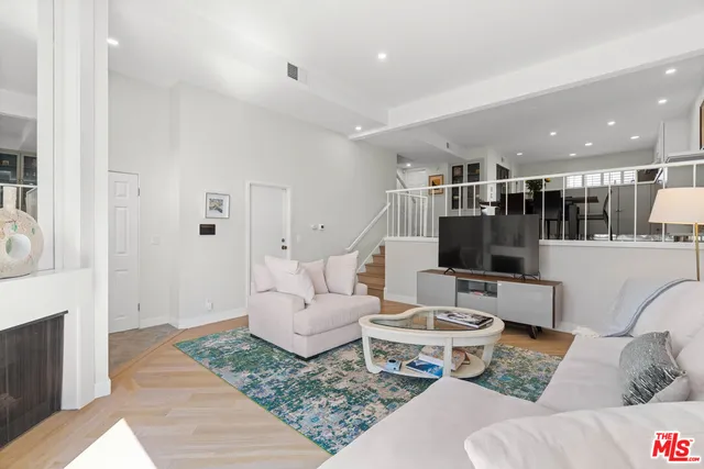 a living room with furniture and kitchen view