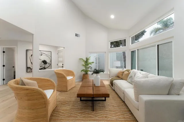 a view of a dining room with furniture a chandelier and wooden floor