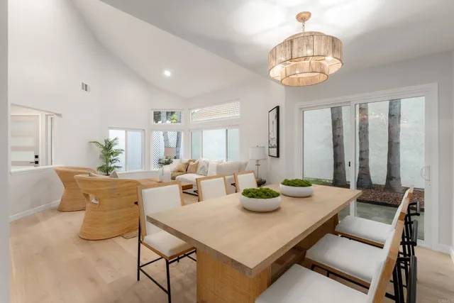 a kitchen with a table chairs refrigerator and microwave