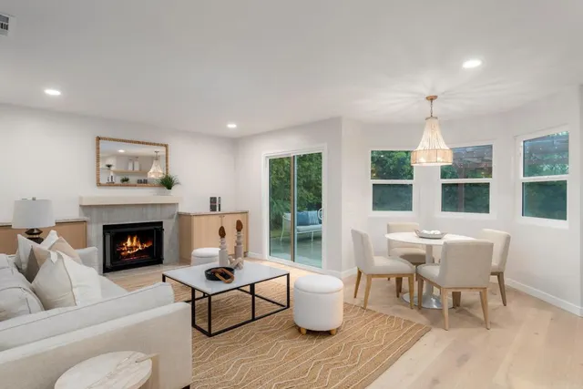 a dining room with furniture a chandelier and wooden floor