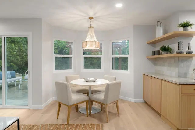 a bathroom with a toilet a sink a mirror a shower and vanity