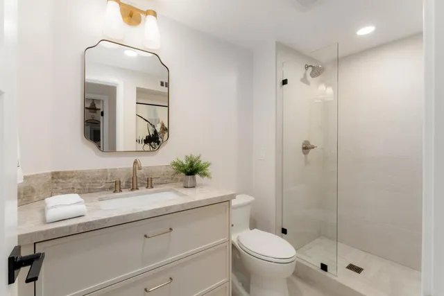 a bedroom with bed and a chandelier