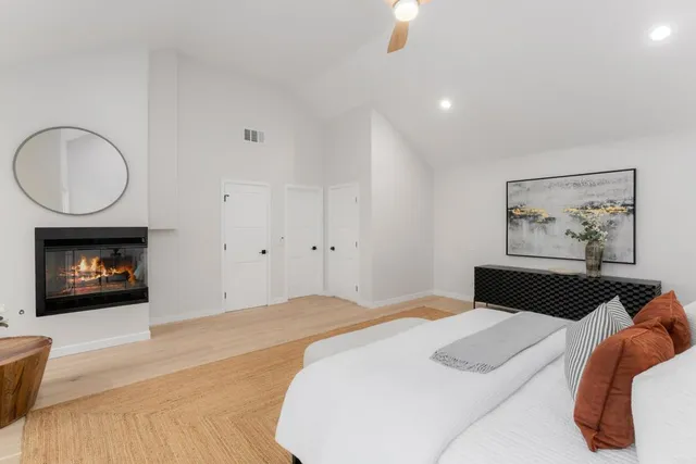 a bedroom with a bed and a fireplace