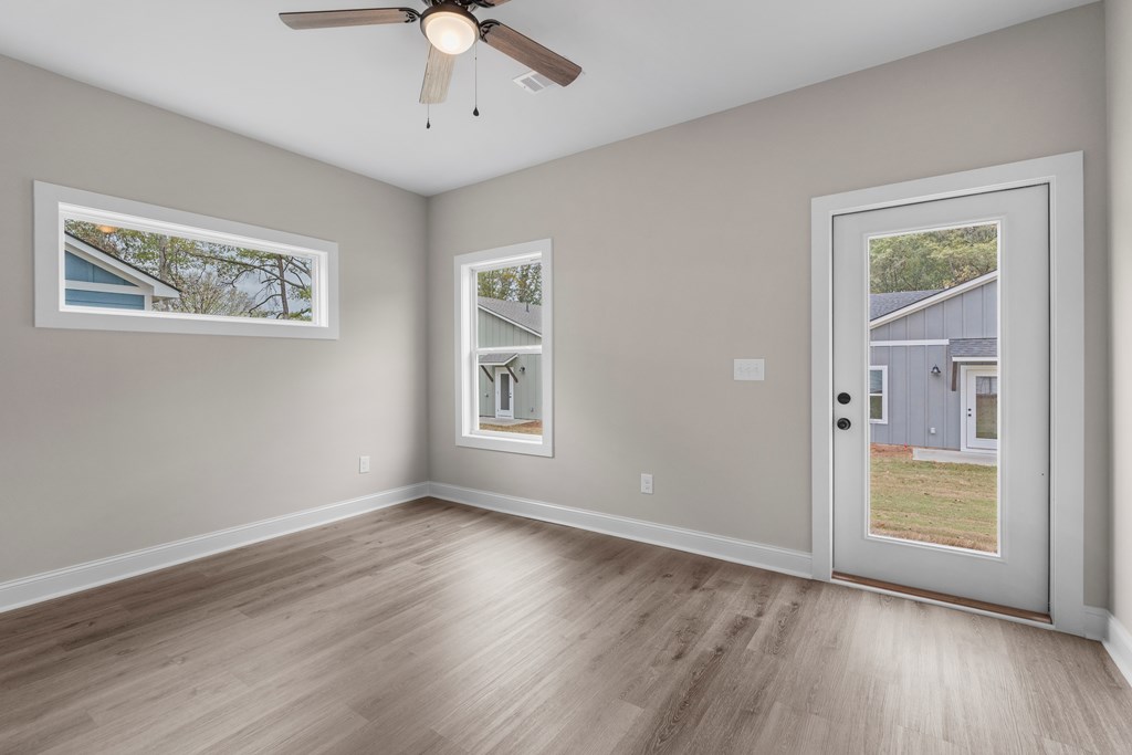 308 Burns Avenue Pine Mountain, GA 31822 - Photo 13 of 17 a view of an empty room with a window and wooden floor