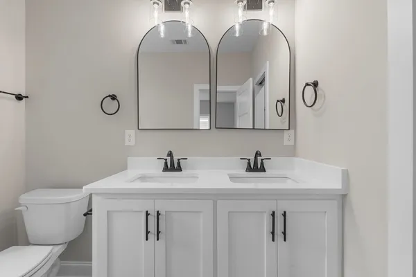 a bathroom with a sink vanity and toilet