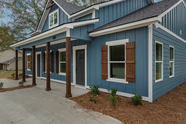 a view of brick house with large windows