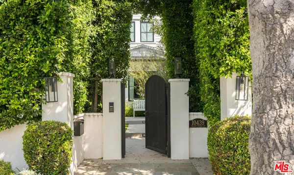 a front view of a house with trees